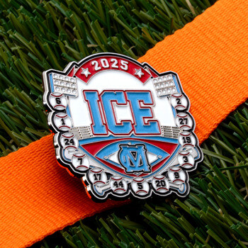 Custom ICE 2025 lapel pin featuring a baseball stadium theme with player numbers and stadium lights on an orange strap over grass.
