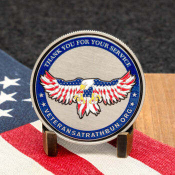 Veterans at Rathbun challenge coin featuring an eagle with American flag wings and the text Thank You For Your Service on a brushed metal background.