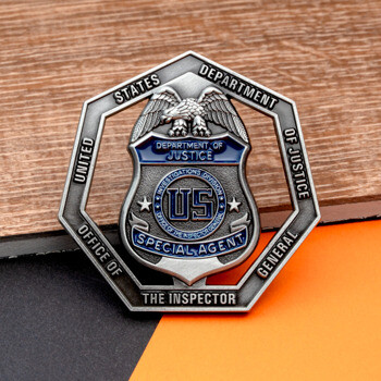 Octagonal cut-out challenge coin for the DOJ Office of the Inspector General featuring a Special Agent badge with eagle and blue enamel.