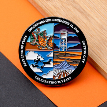 Circular challenge coin featuring four colorful quadrants depicting dancers, a water tower, skydivers, and a mountain landscape.