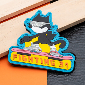 PVC morale patch featuring a black cartoon cat on a pink hoverboard with Fighting 31 text.