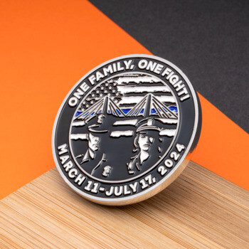 Circular challenge coin featuring two police officers, a bridge, and an American flag with a blue line, inscribed with One Family, One Fight.