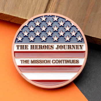 The Heroes Journey challenge coin featuring an American flag design with stars and stripes in a copper finish.