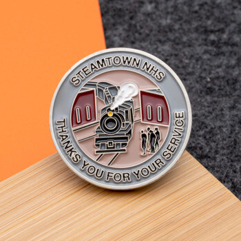 Circular Steamtown NHS challenge coin featuring a steam locomotive engine design with text 'Thanks You For Your Service'.