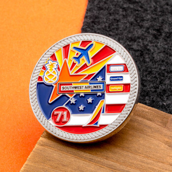 Southwest Airlines custom challenge coin featuring an airplane, stars and stripes, a pineapple, and the number 71 in vibrant colored enamel.