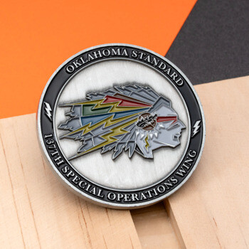 Oklahoma Standard 137th Special Operations Wing challenge coin featuring a colorful Native American chief profile with lightning bolt feathers on a wooden block