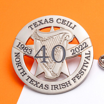 North Texas Irish Festival 40th anniversary silver lapel pin featuring a cutout harp and star design alongside a metal butterfly clutch.